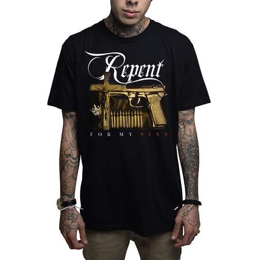 A person wearing a black t-shirt with 'Repent' text and a golden gun design on the front.